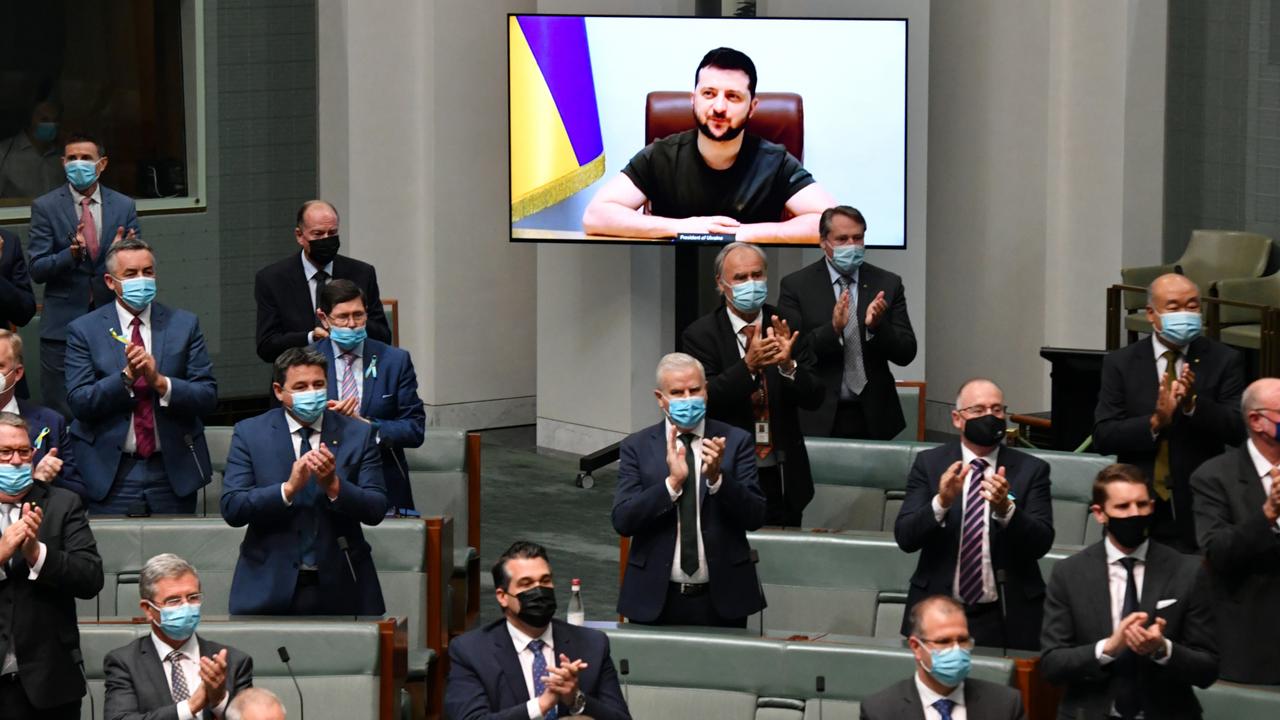 Government members and senators applaud Volodymyr Zelensky before he addresses the House of Representatives via a video link at Parliament House in Canberra. Picture: Mick Tsikas