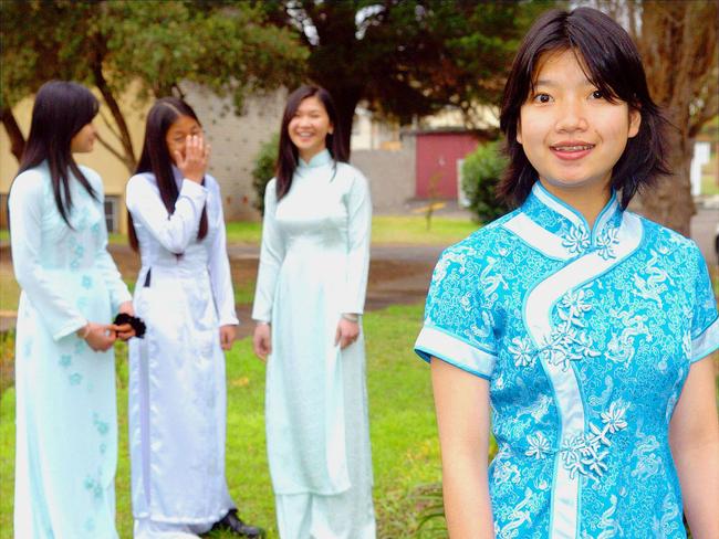 Cabramatta High school students, wearing their Moon Festival gowns, Anna Le, Queenie Trinh and Nikki Nguyen, with Eang Kim Song in foreground in 2004. Picture: Nick Andrean.