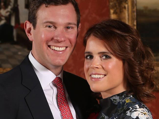 LONDON, ENGLAND -JANUARY 22: (EDITOR'S NOTE: Alternative crop of image #908732602) Princess Eugenie and Jack Brooksbank pose in the Picture Gallery at Buckingham Palace after they announced their engagement. Princess Eugenie wears a dress by Erdem, shoes by Jimmy Choo and a ring containing a padparadscha sapphire surrounded by diamonds on January 22, 2018 in London, England..  They are to marry at St Georges Chapel in Windsor Castle in the autumn this year. (Photo by Jonathan Brady - WPA Pool/Getty Images)