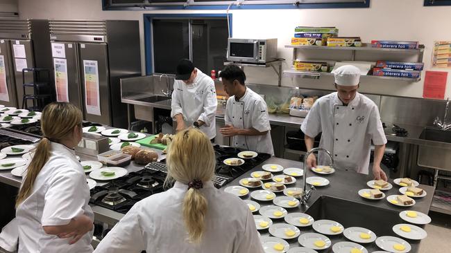 Golinski and the students preparing for service on the first night of the school's dinner.