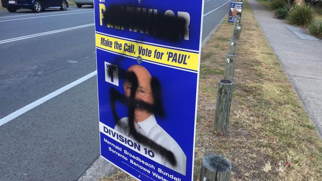 Paul Taylor’s defaced signs bearing the swastika.