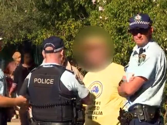 A supporter of Clive Palmer's Australia United Party is pictured after he was issued a fine for offensive conduct at a polling booth in Bankstown. Picture: SBS