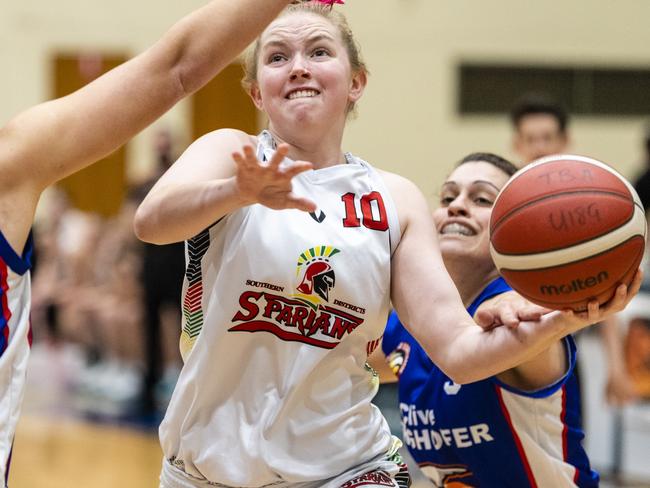 Alice Dart of SD Spartans defended by Mia Stower (left) and Tracey Twidale of Toowoomba Mountaineers in Queensland State League Division 1 womens basketball round 12 at USQ's Clive Berghofer Recreation Centre, Sunday, July 24, 2022. Picture: Kevin Farmer