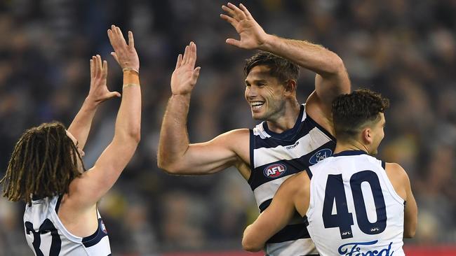 Gryan Miers, Tom Hawkins and Luke Dalhaus celebrate a goal during Friday night’s victory over Richmond. Picture: AAP Image/Julian Smith.