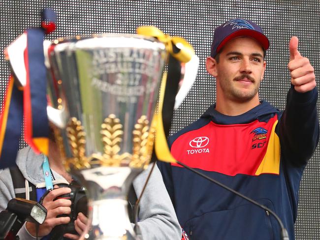 Taylor Walker gestures next to the Premiership Cup after showing it to the crowd during the 2017 AFL Grand Final parade in Melbourne. Picture: Scott Barbour/Getty Images