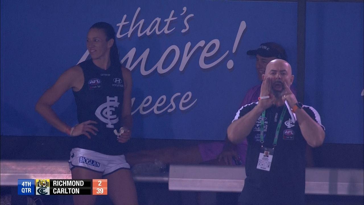 Andy Maher, trying to hide behind Carlton AFLW coach Daniel Harford, had ice on his calf at the end of the game.
