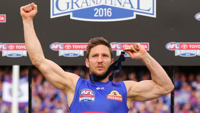 MELBOURNE, VICTORIA — OCTOBER 01: Matthew Boyd of the Bulldogs celebrates the win on the podium during the 2016 AFL Grand Final match between the Sydney Swans and the Western Bulldogs at Melbourne Cricket Ground on October 1, 2016 in Melbourne, Australia. (Photo by Michael Dodge/AFL Media/Getty Images)