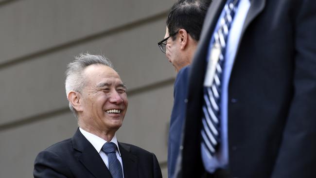 Chinese Vice Premier Liu He is greeted by Treasury Secretary Steve Mnuchin as he arrives for trade talks in Washington. Pic: AP