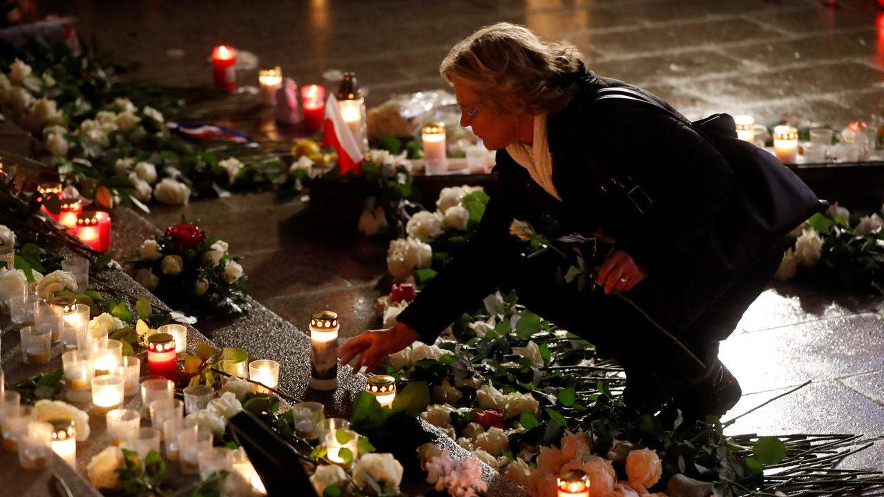 A visitor leaves a candle at a memorial for the victims of the 2016 deadly truck attack at the Christmas market at Breitscheidplatz in front of the Kaiser-Wilhelm-Gedaechtniskirche (Kaiser Wilhelm Memorial Church). Picture: AFP PHOTO / Odd ANDERSEN