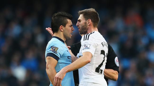 Sergio Aguero of Manchester City confronts Angel Rangel of Swansea City.