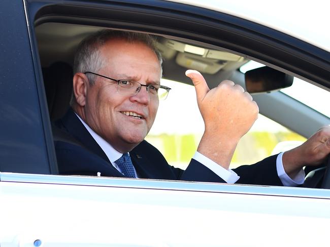 Scott Morrison test drives a hydrogen-fuelled car around a Toyota test track in Melbourne. The prime minister visited the Toyota Hydrogen Centre in Altona to unveil a new $250m electric vehicle plan.