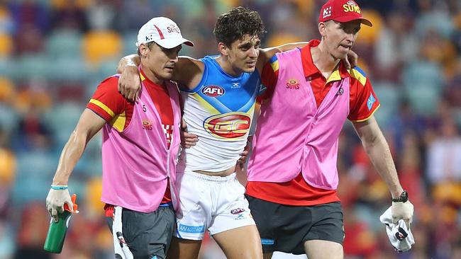 Sean Lemmens was helped from the field after injuring his ankle. Picture: Getty