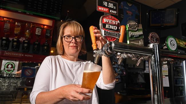 Verity Ferguson, co-owner of Southwark Hotel in Adelaide, pours pints of West End after the news the beer will no longer be brewed in South Australia. Picture: Tom Huntley