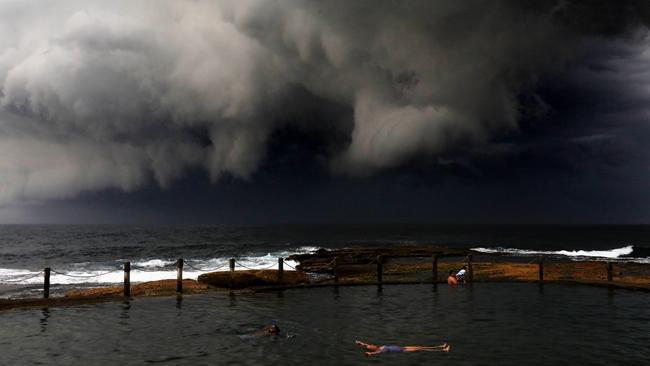 People brave the storm as it rolls in at Mahon Pool, Maroubra. Picture: Brianne Makin