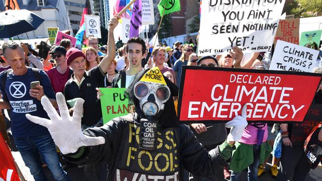 Extinction Rebellion protesters are seen blocking the corner of Margaret and William Streets in Brisbane on Tuesday, August 6. Picture: AAP Image/Darren England