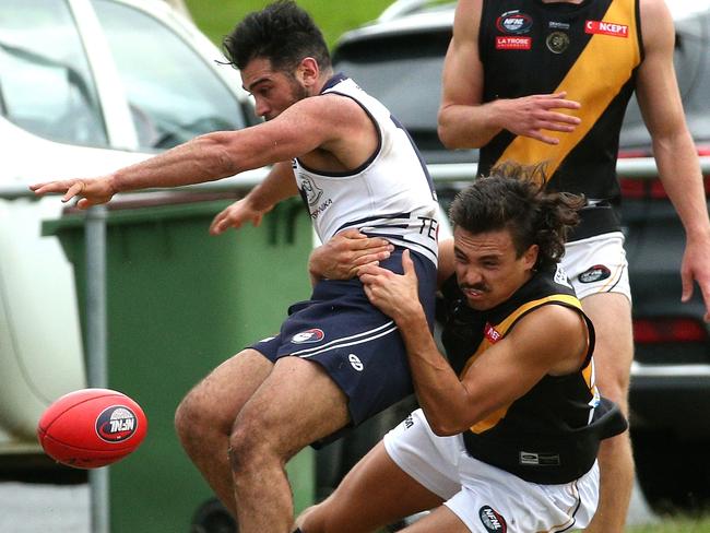 NFL: Daniel Younan of Bundoora is tackled by Heidelberg’s Sean Martin. Picture: Hamish Blair