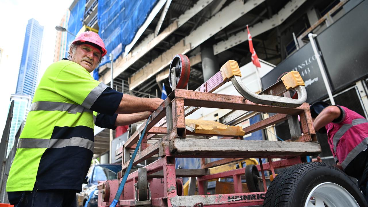 Workers packing from the 443 Queen St apartment tower project in Brisbane.