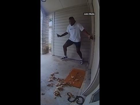 Man loses it after finding snake at his front door