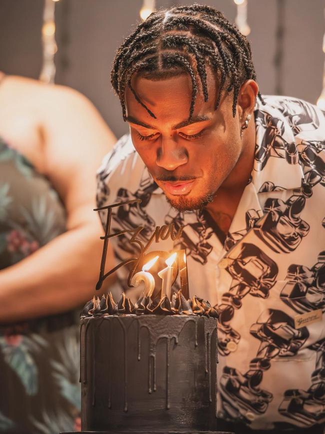 Ezra Mam's blowing out the candles on his birthday cake at his 21st birthday party. Photo: Instagram/@ezra.mam