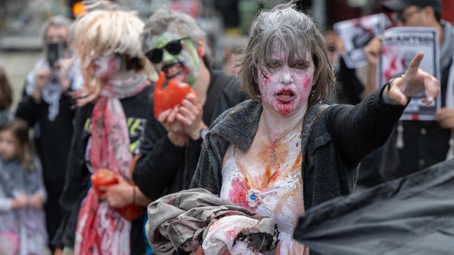 A wave of ‘zombies’, waving fake body parts, capped off three days of anti-war protests at the Land Forces expo. Picture: Tony Gough