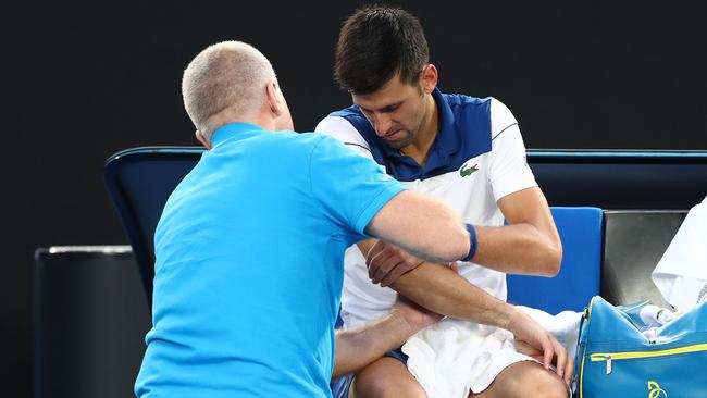 Novak Djokovic gets running repairs in his fourth round match. Picture: Getty