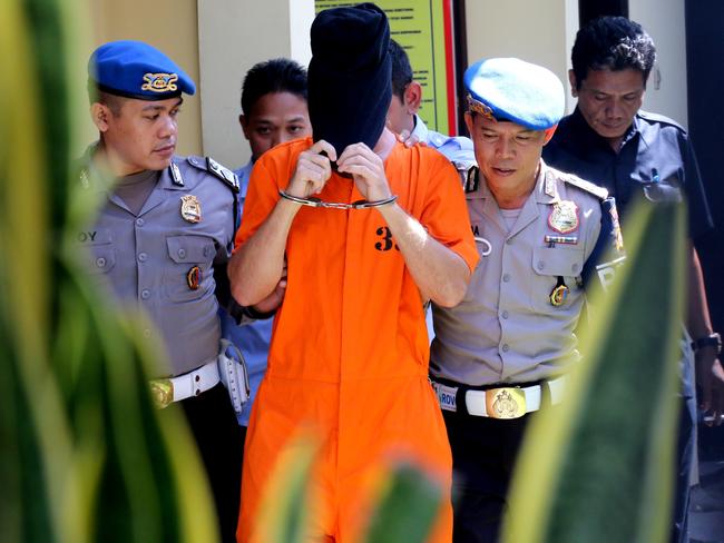 David Taylor is escorted by the police to meet British Consulate Staff at Denpasar Police Station. Picture: Lukman S.Bintoro