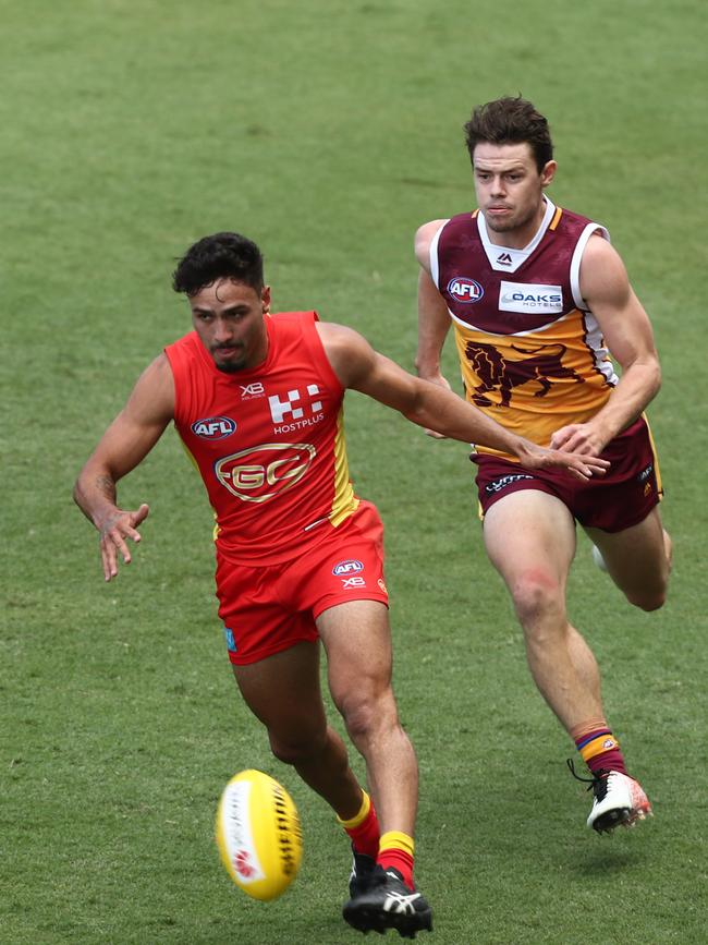Izak Rankine of the Suns gets a kick away. Picture: Getty Images