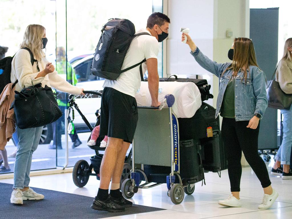 AFL players, their wives, girlfriends and families are headed too Queensland. Matthew Kreuzer gets his temperature check by Nadine Rabah from the AFL. Picture: Mark Stewart