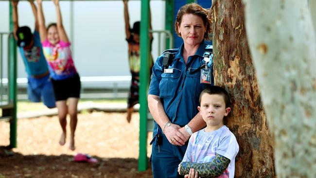 Metro South Paramedic Jane James, with Christopher French, 5, of Cedar Vale, who fell off a retaining wall. Picture: Peter Cronin