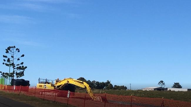 Diggers stop work at the site of a proposed temporary sewerage holding facility where two big black septic tanks were being installed at Redland Bay after problems with run-off and excess water.