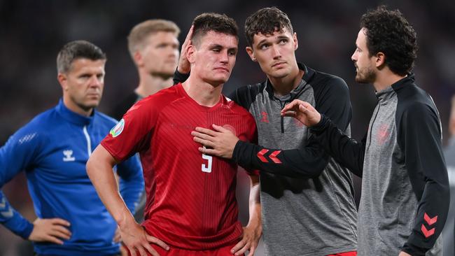 Andreas Christensen and Thomas Delaney of Denmark console teammate Joakim Maehle who is in tears following their team's defeat. Picture: Getty Images.