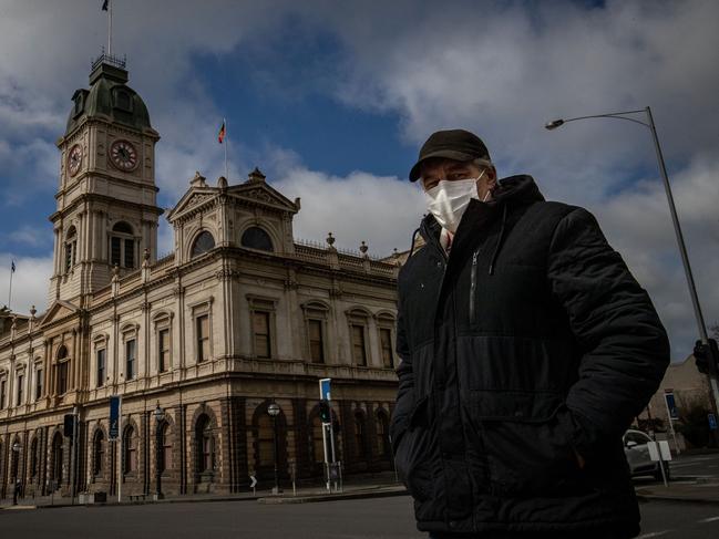 BALLARAT, AUSTRALIA - AUGUST 21: A man wearing a mask walks across Sturt Street in Ballarat on August 21, 2020 in Ballarat, Australia. COVID-19 testing in Ballarat has increased as health authorities work to avoid the spread of coronavirus in regional Victoria. Metropolitan Melbourne is under stage 4 lockdown restrictions, with people only allowed to leave home to give or receive care, shopping for food and essential items, daily exercise and work while an overnight curfew from 8pm to 5am is also in place. The majority of retail businesses are also closed. Other Victorian regions are in stage 3 lockdown. The restrictions, which came into effect from 2 August, have been introduced by the Victorian government as health authorities work to reduce community COVID-19 transmissions across the state. (Photo by Darrian Traynor/Getty Images)