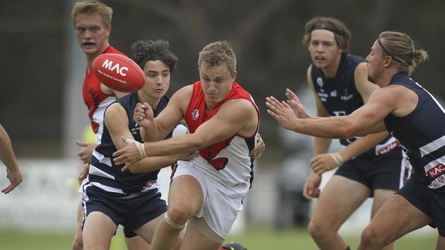 Flagstaff Hill's Brad Patterson under pressure from Noarlunga's Hayden Case-Peach. Picture: AAP/Dean Martin