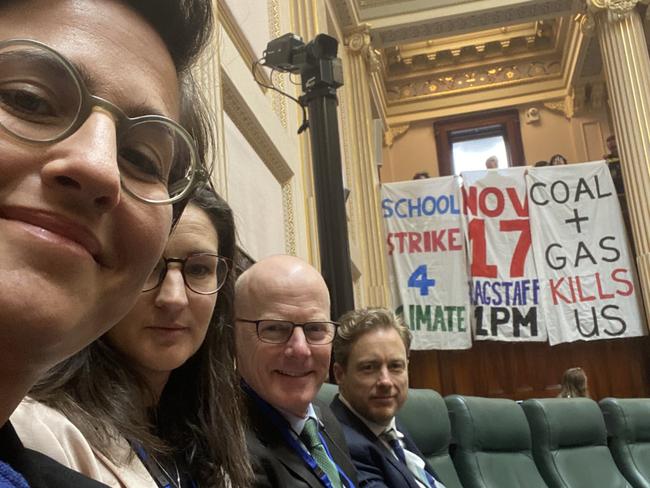 The Greens MPs pose for a photo with the climate protesters.