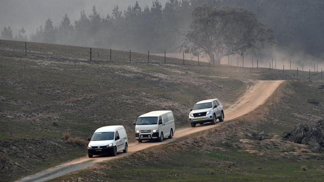 NSW forensic officers and a coronial van leave the crash site at Peak View, in NSW’s south, on Friday. Picture: Sam Mooy/Getty Image.