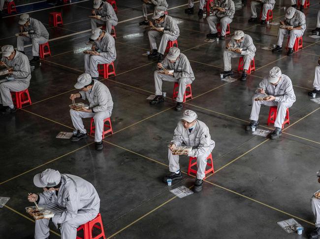 Employees eating during lunch break at an auto plant of Dongfeng Honda in Wuhan in China's central Hubei province.