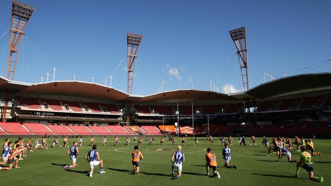 GWS Giants and North Melbourne players take a knee before their Round 2 match.