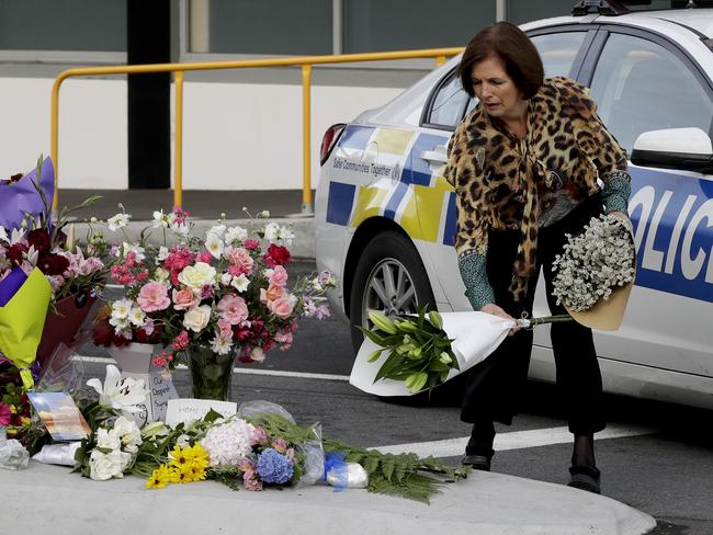 A woman places flowers at a makeshift memorial near the mosque in Christchurch. Picture: AP Photo/Mark Baker