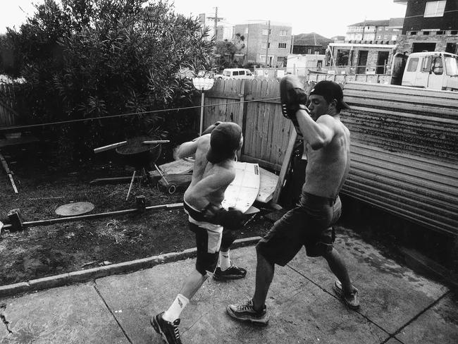 Richie 'Vas' Vaculik hitting the pads with Koby Abberton in his backyard in 2000. Picture: Billy Morris