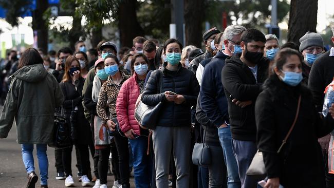 Crowds of people defy social distancing rules to wait in line to receive a COVID-19 vaccination at the NSW vaccination hub in Sydney. Picture: Bianca De Marchi