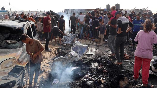 Palestinians gather at the site of an Israeli strike on a camp for internally displaced people in Rafah on May 27, 2024, amid ongoing battles between Israel and the Palestinian Hamas militant group. (Photo by Eyad BABA / AFP)