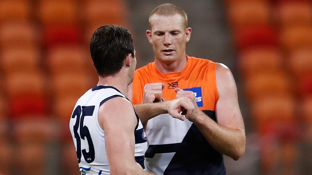 GWS ruckman Big Sauce catches up with Geelong’s Patrick Dangerfield. (AAP Image/Brendon Thorne)