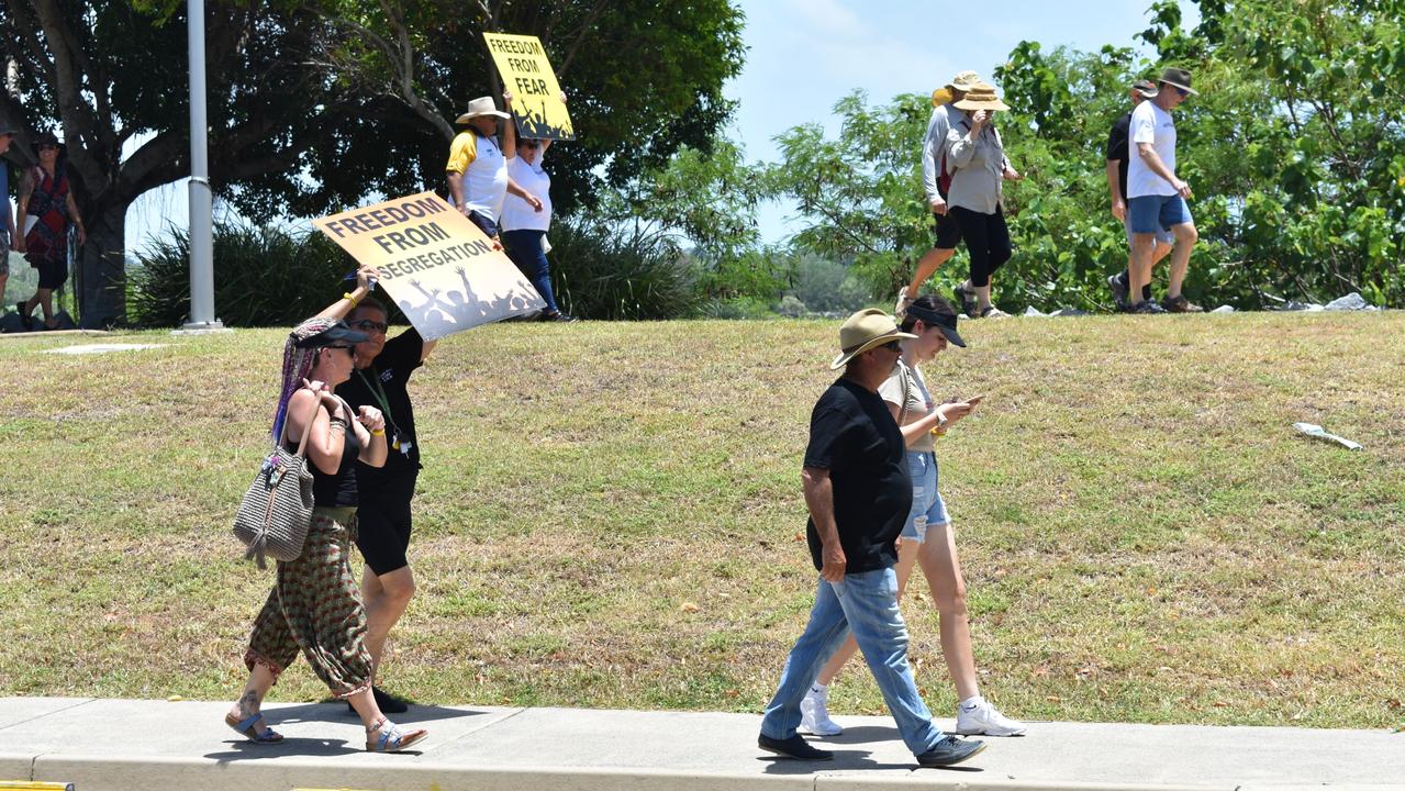 At least 100 people formed the crowd that marched on Caneland Central in Mackay.