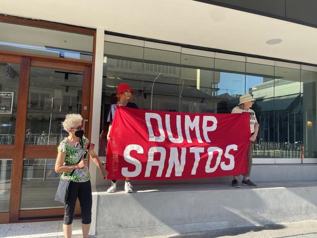 Protestors held "DUMP SANTOS" signs outside the Santos building. Picture: Isabel McMillan