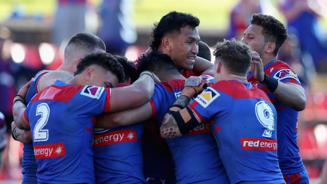 Newcastle Knights celebrate a crucial try.