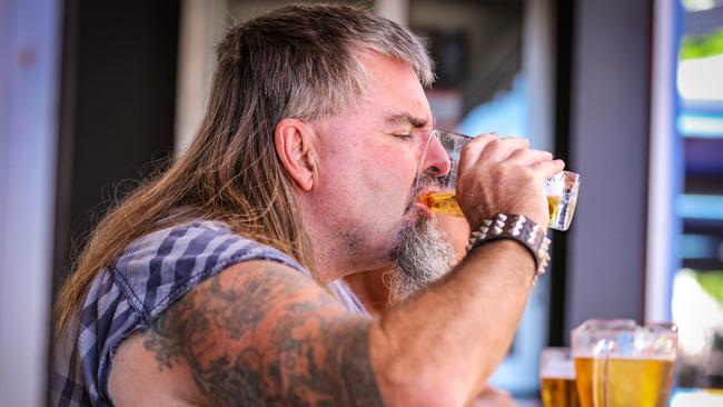 Darrell Matuschka enjoys his first beer out on Mitchell St as Darwin's 72 hour lock down ends at midday. Picture Glenn Campbell