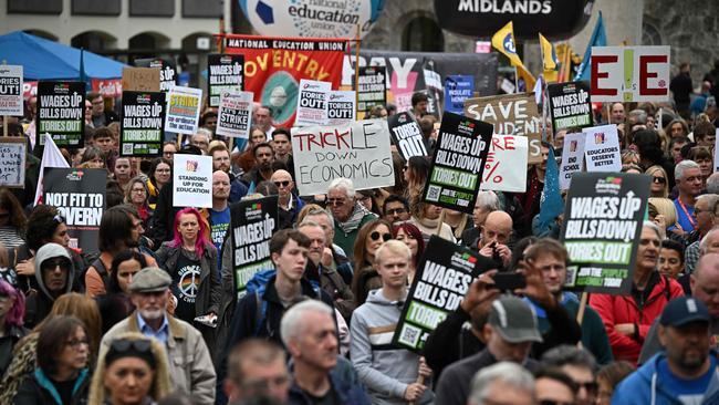 Protesters hold up placards at an anti-government protest in Birmingham in 2022. Picture: AFP