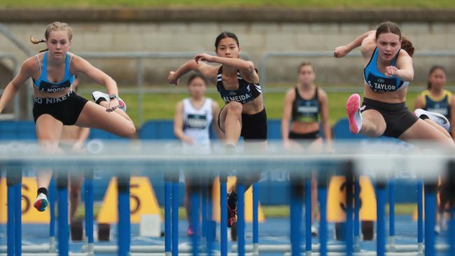 Jordan Moore, left, of Woolooware High School in the 14 years girls 90m hurdles.