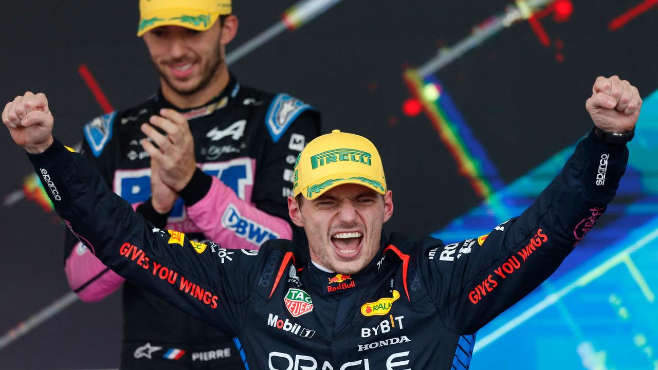 Red Bull Racing's Dutch driver Max Verstappen celebrates at the podium after winning the Formula One Sao Paulo Grand Prix. (Photo by Miguel Schincariol / AFP)