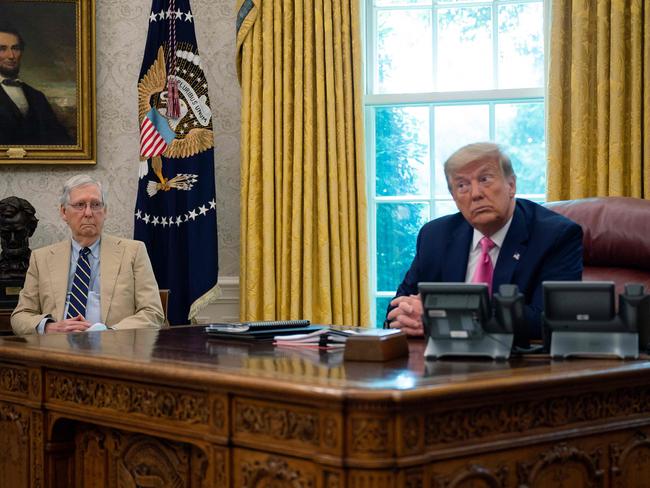 (FILES) In this file photo taken on July 20, 2020 US President Donald Trump speaks with Senate Majority Leader Mitch McConnell (L), R-KY, in the Oval Office at the White House in Washington, DC, meeting to discuss children, jobs and vaccines. - Mitch McConnell bridled over Donald Trump's crude governing style but found him a valuable White House ally. Now, the powerful US Senate majority leader controls the outgoing president's political future. (Photo by JIM WATSON / AFP)